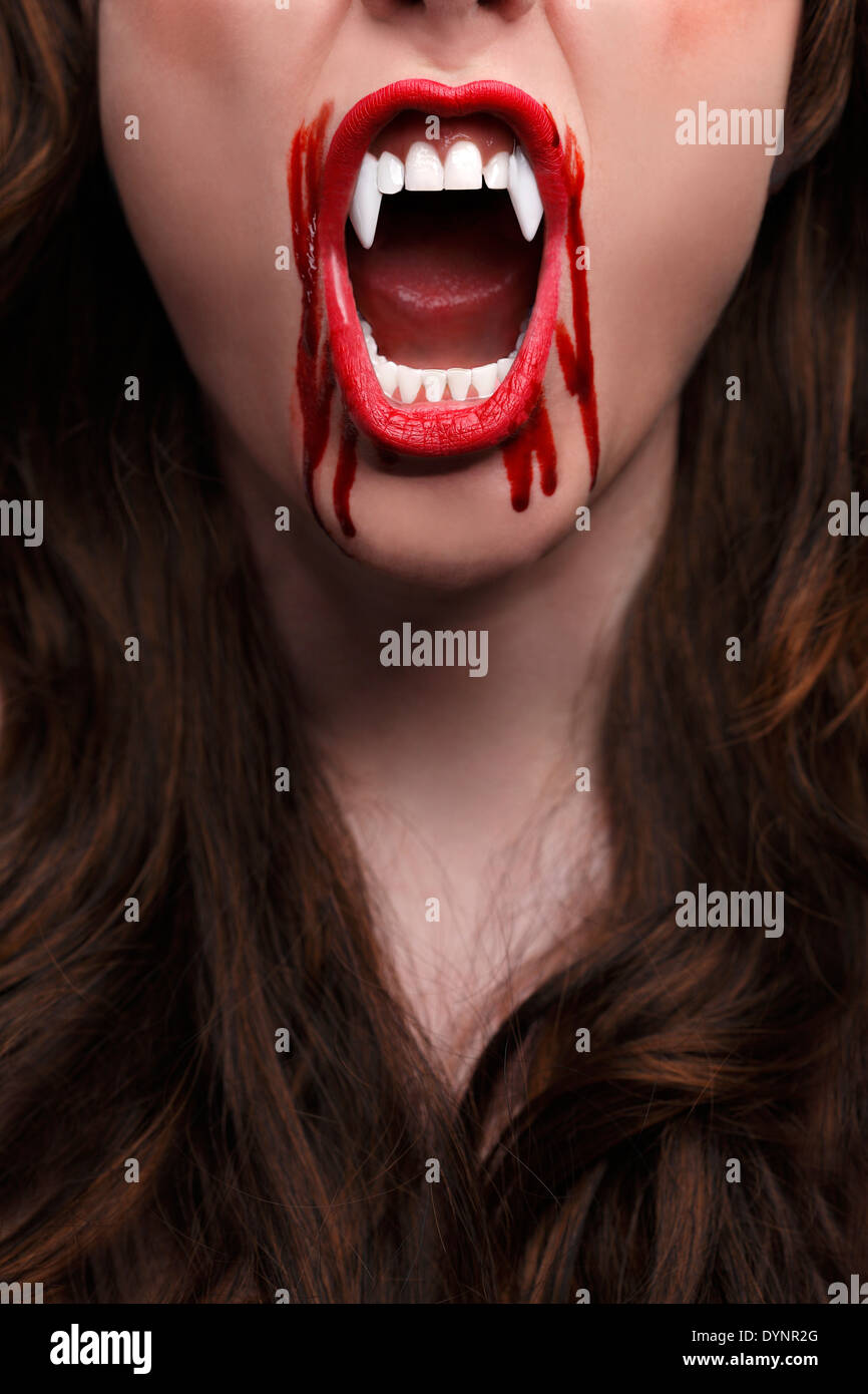 Female vampire with bloody teeth Stock Photo
