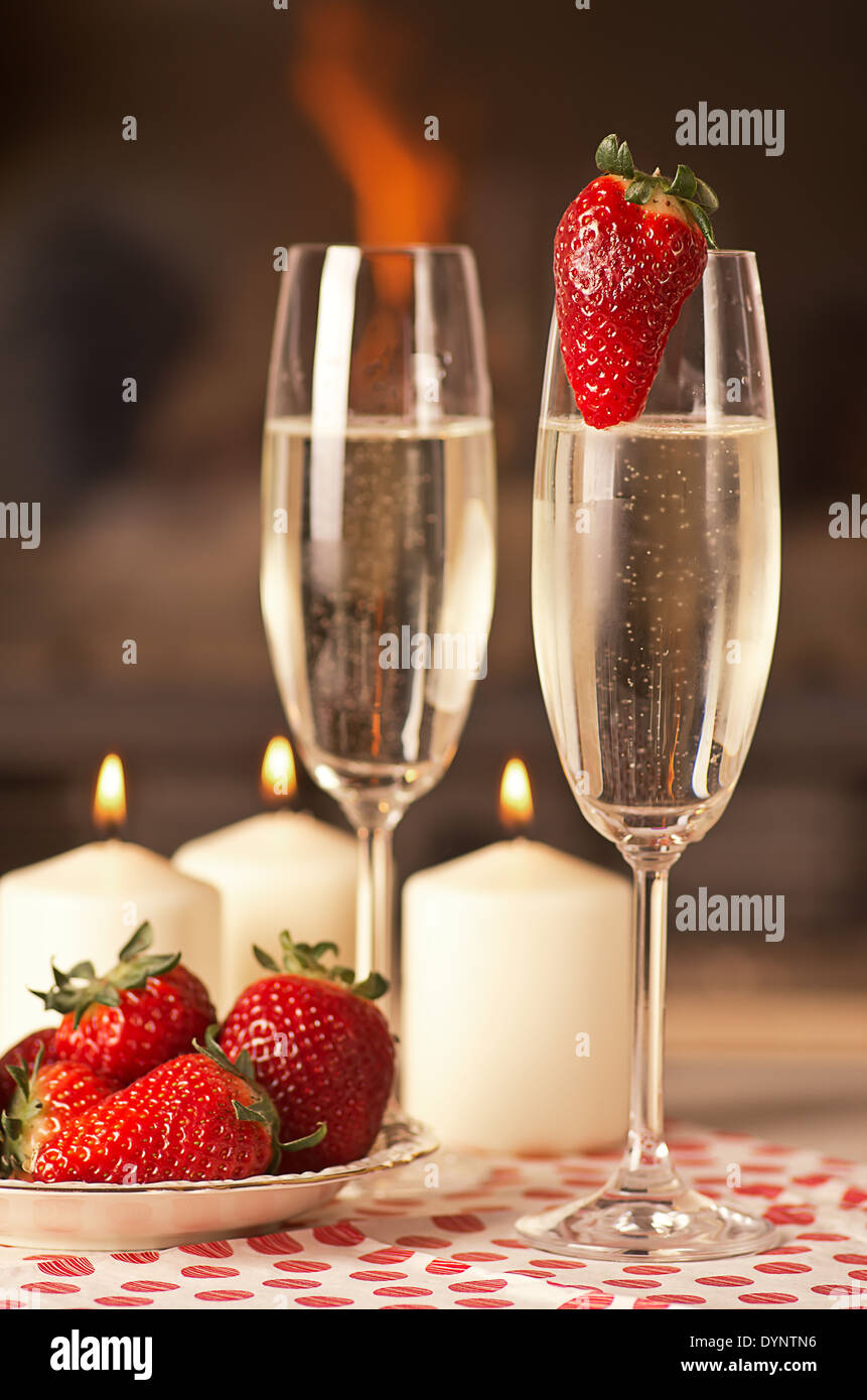Champagne, strawberries and candles for a romantic evening Stock Photo