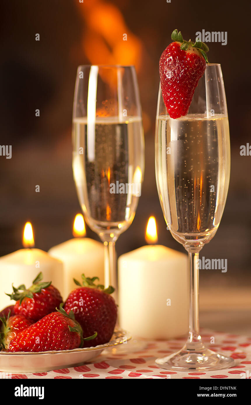 Champagne, strawberries and candles for a romantic evening Stock Photo