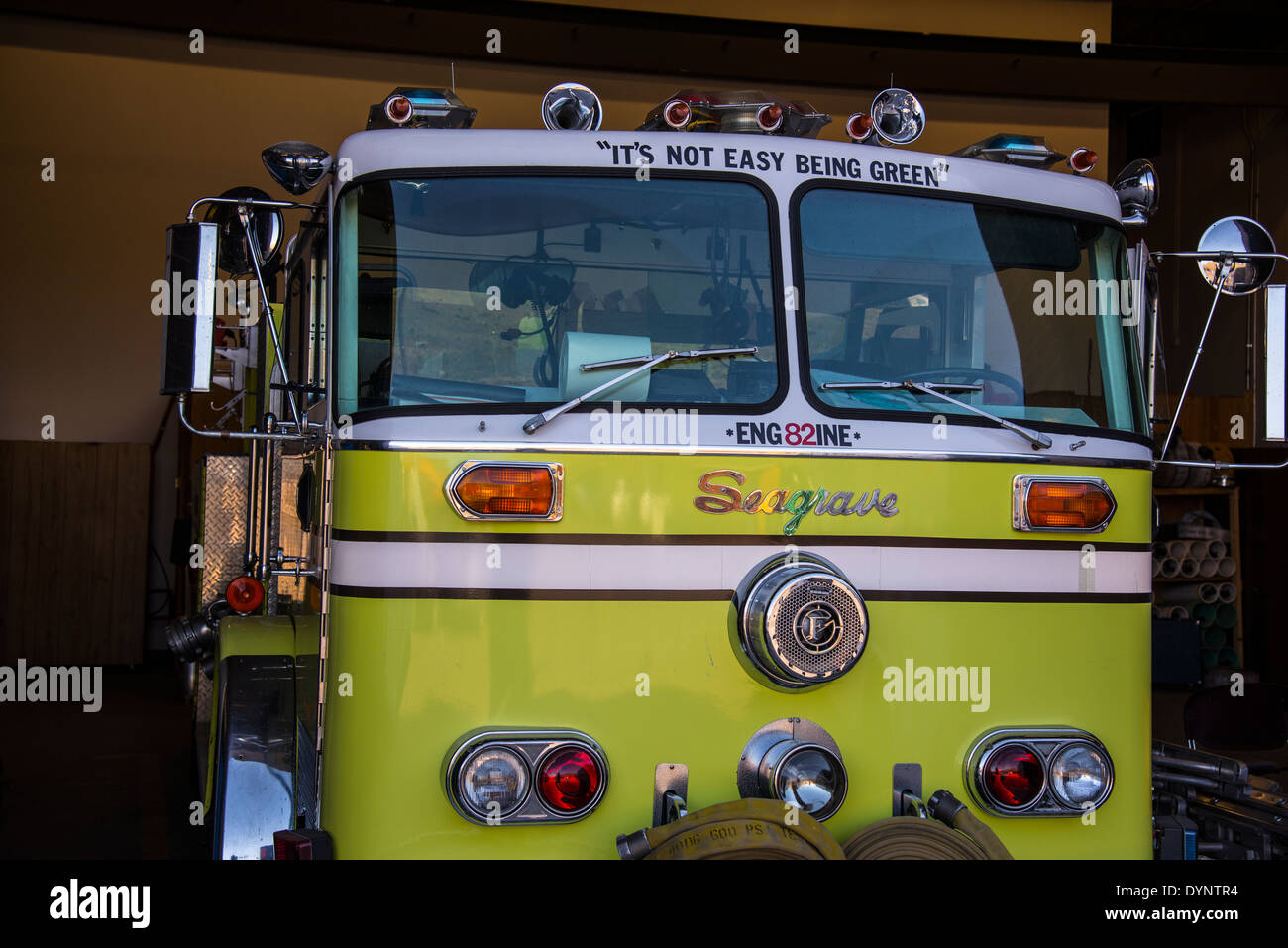 green fire engine parked in garage Stock Photo