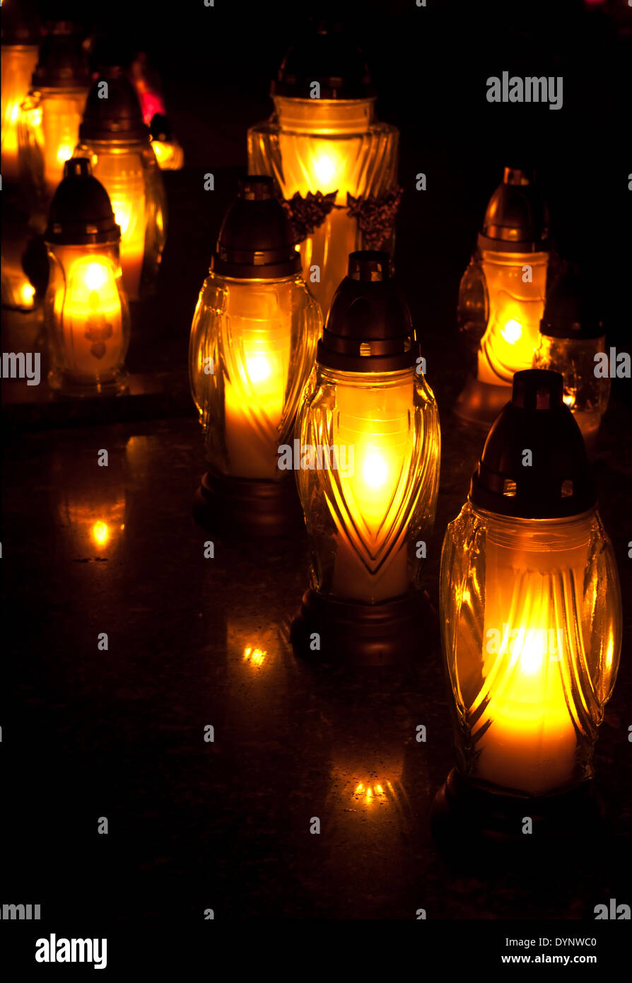 Yellow identical candles at the cemetery Stock Photo Alamy