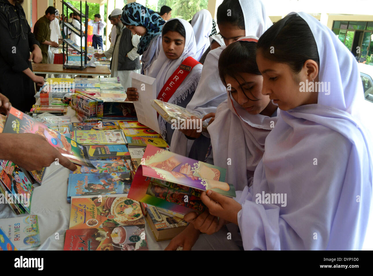 Quetta. 23rd Apr, 2014. Students read books at a book stall on World Book Day in southwest Pakistan's Quetta on April 23, 2014. © Asad/Xinhua/Alamy Live News Stock Photo