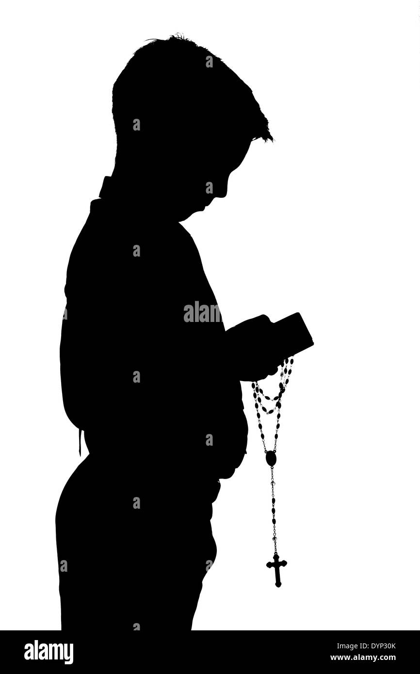Silhouette of young boy in his First Holy Communion Stock Photo
