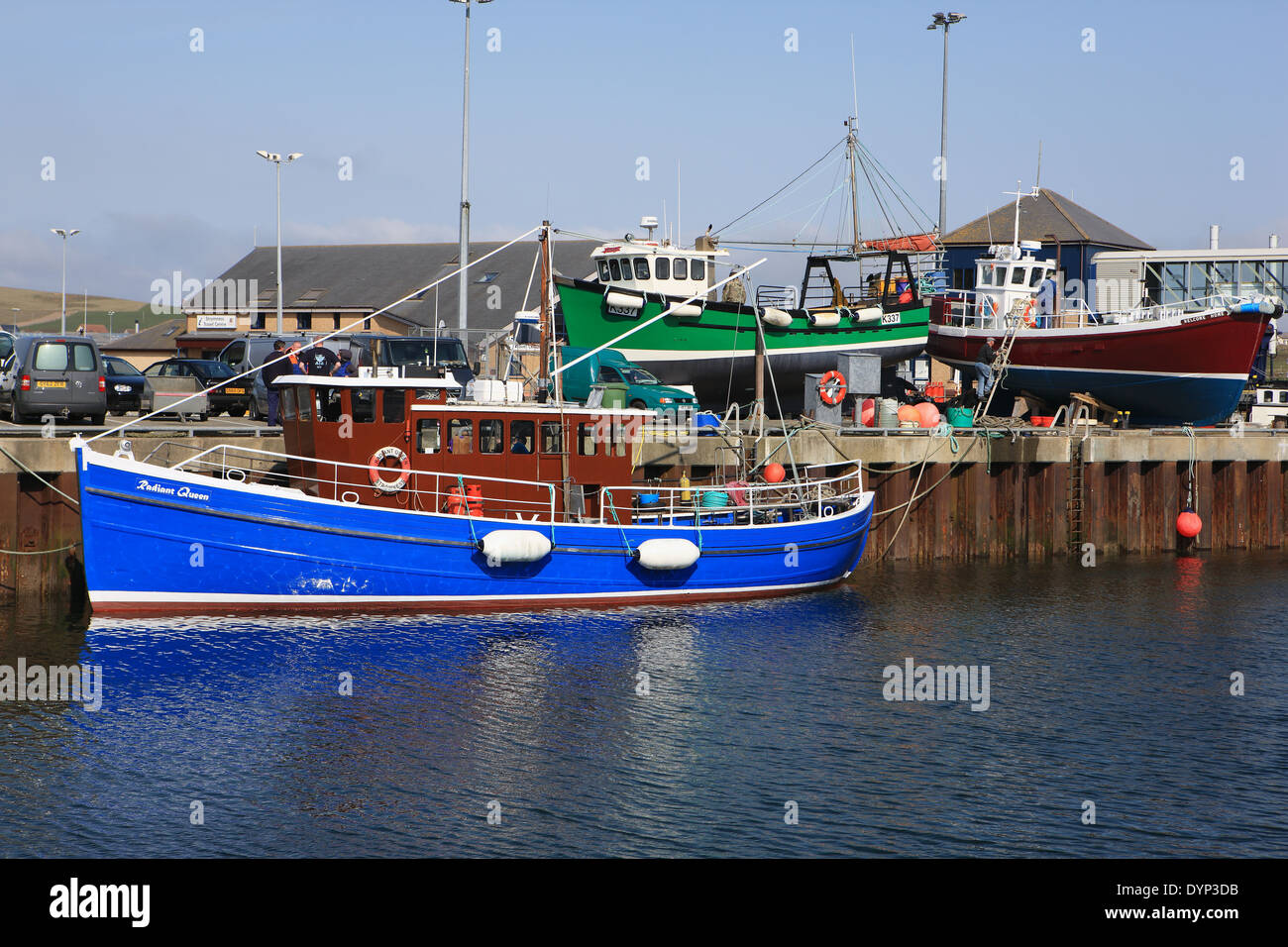 Colourful fishing boats in Stromness harbour in Orkney Stock Photo