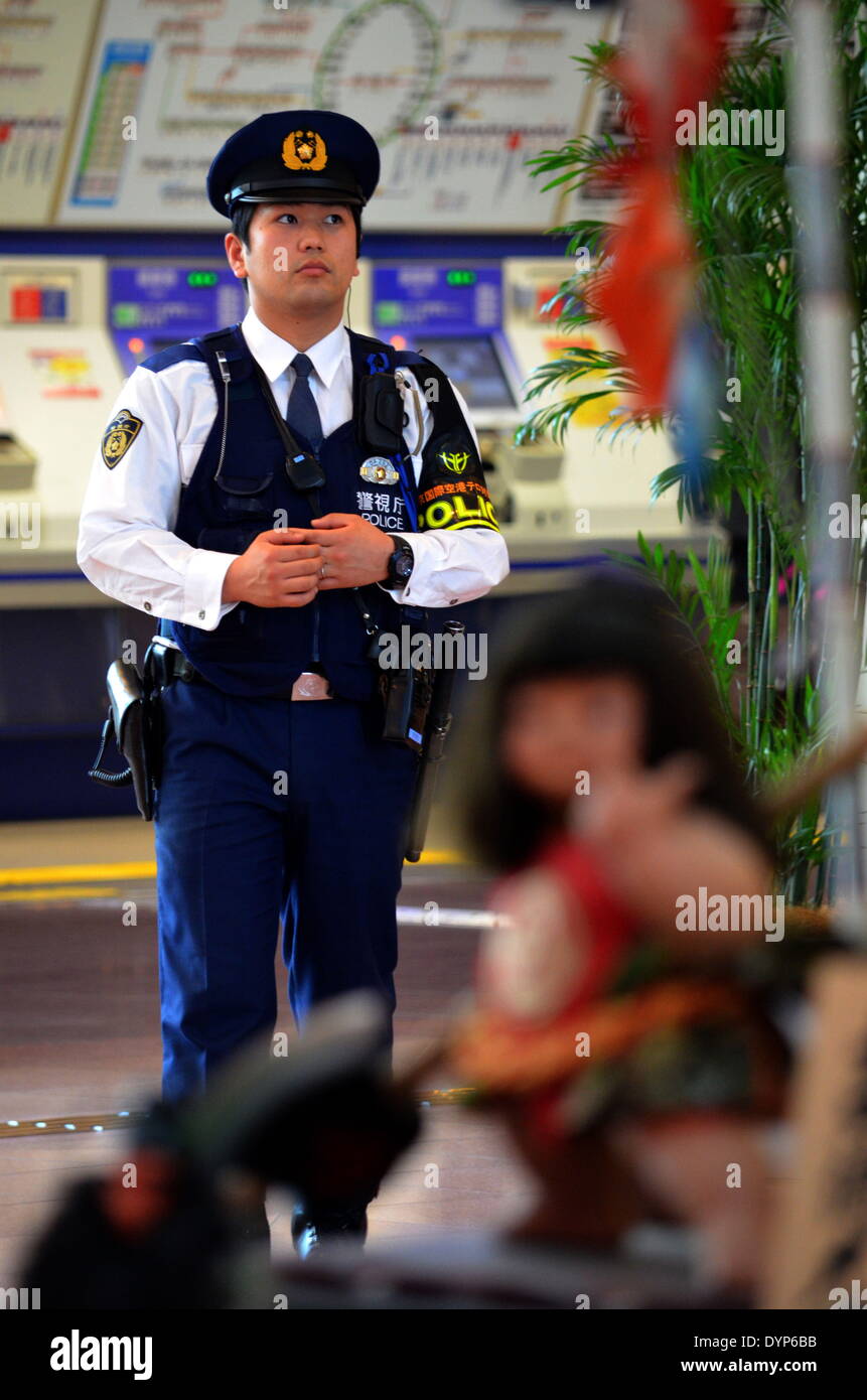 Ota, Tokyo, Japan. 23rd Apr, 2014. A Japanese police officer walks along the International Passenger Terminal Area at the Haneda Airport. The U.S. President s expected to arrive in Japan today. © Agustin Tabares/ZUMA Wire/ZUMAPRESS.com/Alamy Live News Stock Photo