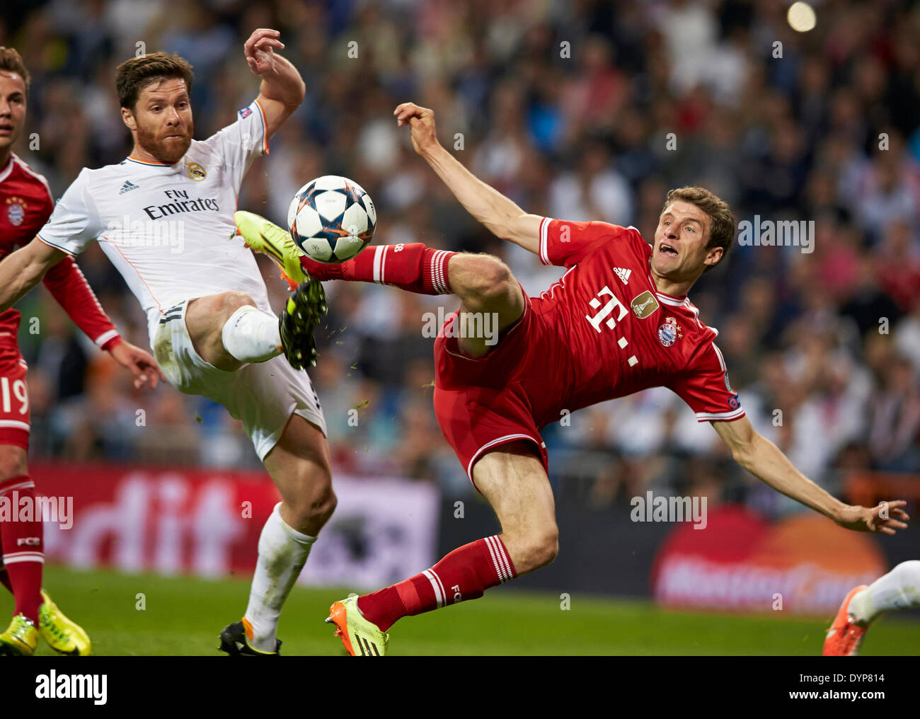 Madrid, Spain. 23rd Apr, 2014. Midfielder Xabi Alonso of Real Madrid (L) duels for the ball with Thomas MULLER during the UEFA Champions League Game between Real Madrid and FC Bayern Munich at Santiago Bernabeu Stadium, Valencia Credit:  Action Plus Sports/Alamy Live News Stock Photo