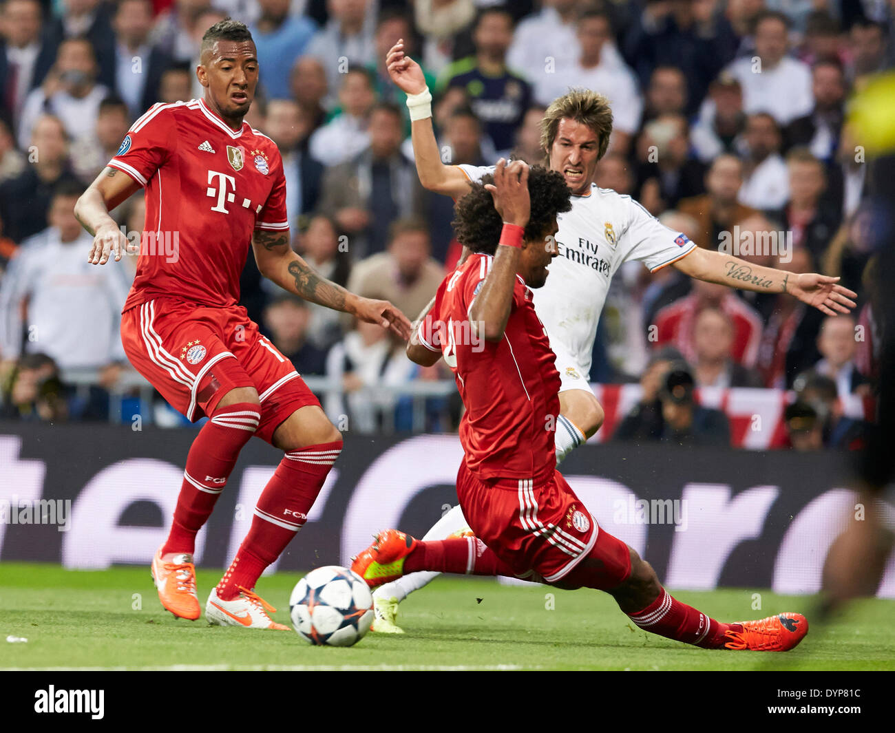 Madrid, Spain. 23rd Apr, 2014. Defender Fabio Coentrao of Real Madrid (L) centers the ball challenged by Dante (C) during the UEFA Champions League Game between Real Madrid and FC Bayern Munich at Santiago Bernabeu Stadium, Valencia Credit:  Action Plus Sports/Alamy Live News Stock Photo