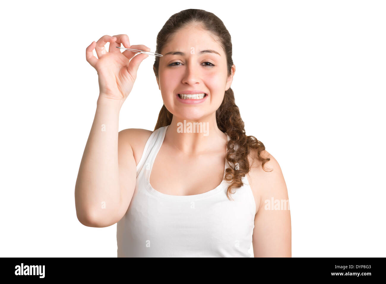 Woman plucking her eyebrows with a painfull look on her face, isolated Stock Photo