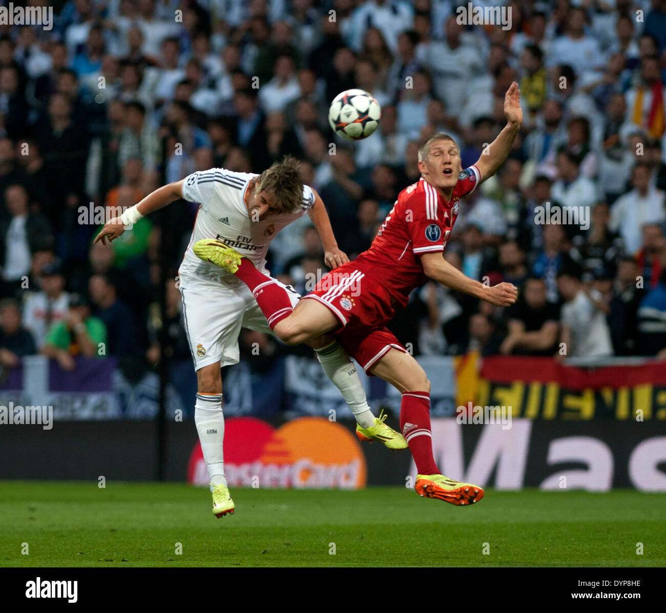 Madrid, Spain. 23rd Apr, 2014. Real Madrid's Fabio Coentrao (L) vies with Bayern Munich's Bastian Schweinsteiger during their UEFA Champion League semi-final first leg soccer match in Madrid, Spain, April 23, 2014. Real Madrid won the match 1-0. © Xie Haining/Xinhua/Alamy Live News Stock Photo