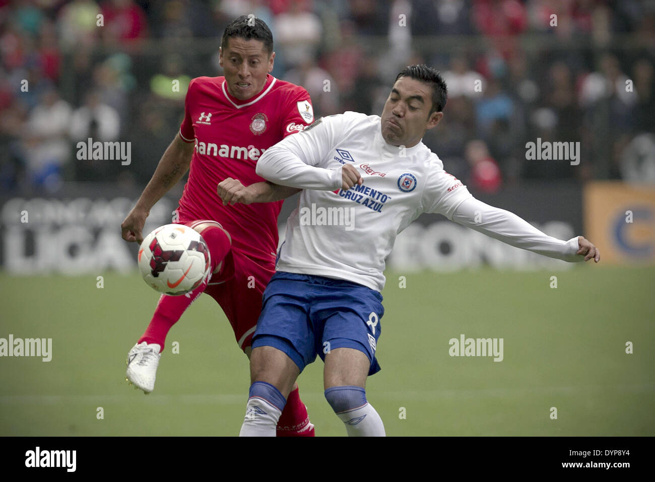 Toluca, Mexico. 23rd Apr, 2014. Toluca's Carlos Esquivel (L) vies for the ball with Marco Fabian of Cruz Azul during the second leg match of the CONCACAF Champions League Final at Nemesio Diez Stadium in Toluca, State of Mexico, Mexico, on April 23, 2014. © Alejandro Ayala/Xinhua/Alamy Live News Stock Photo