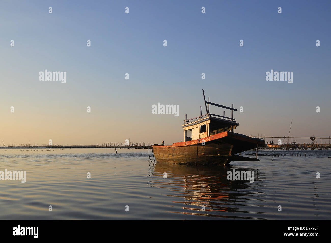 old fishing boat at sunset time Stock Photo