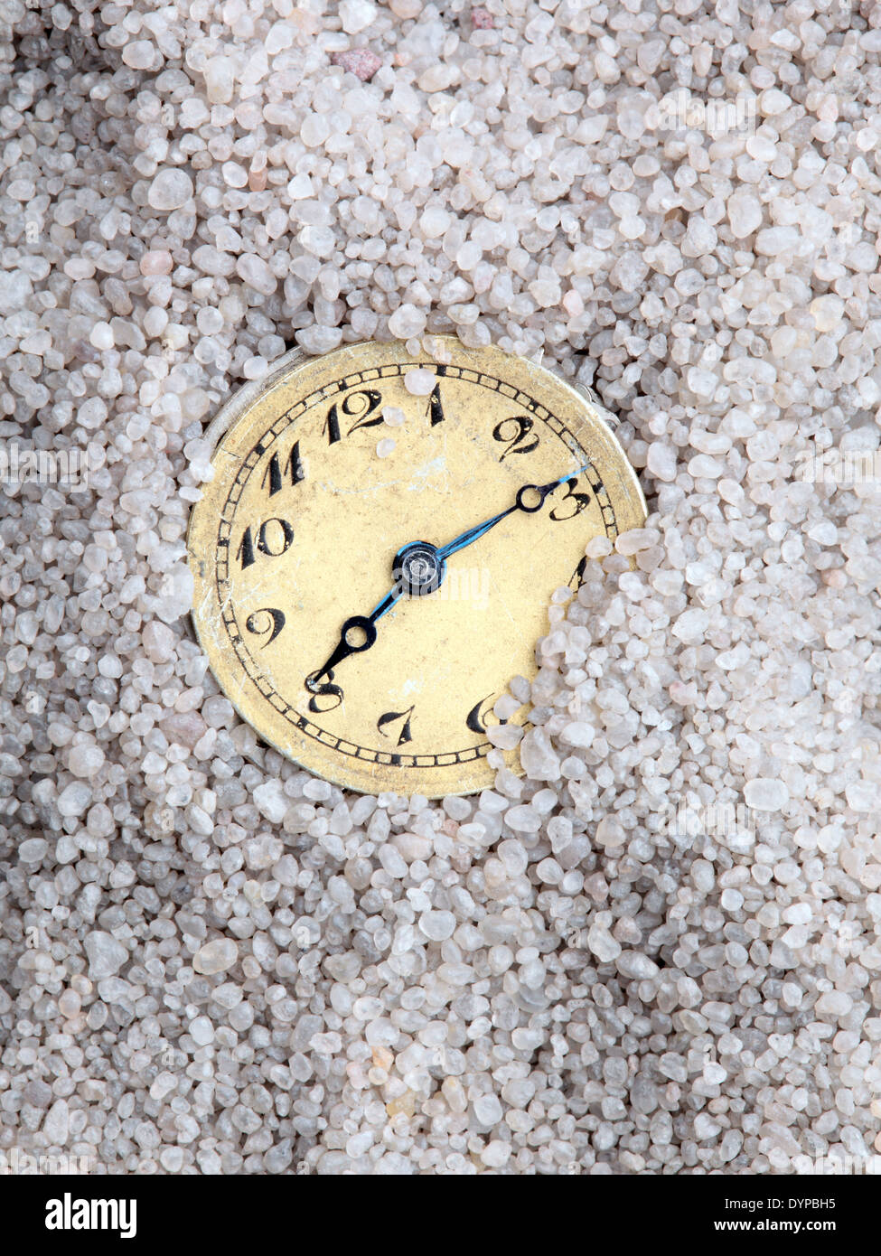 antique clock buried in sand Stock Photo Alamy