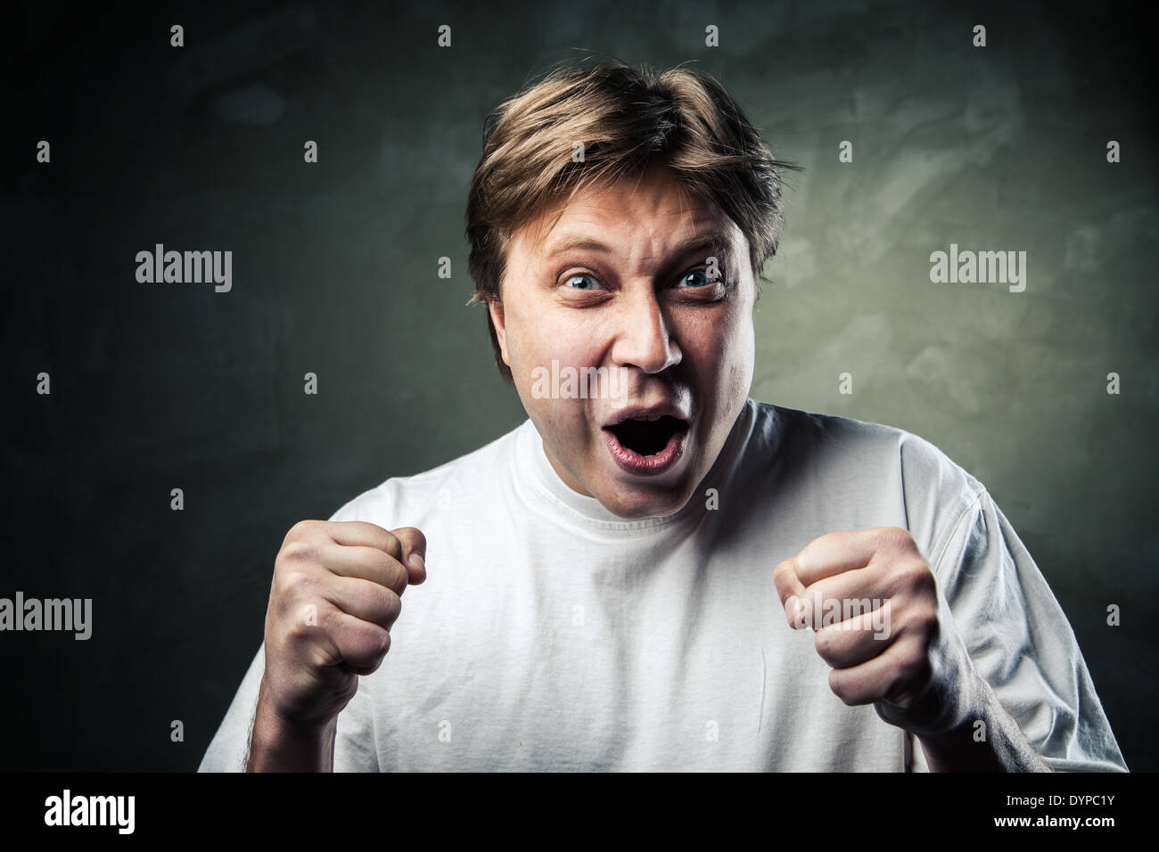 Laughing young man over gray texture background Stock Photo