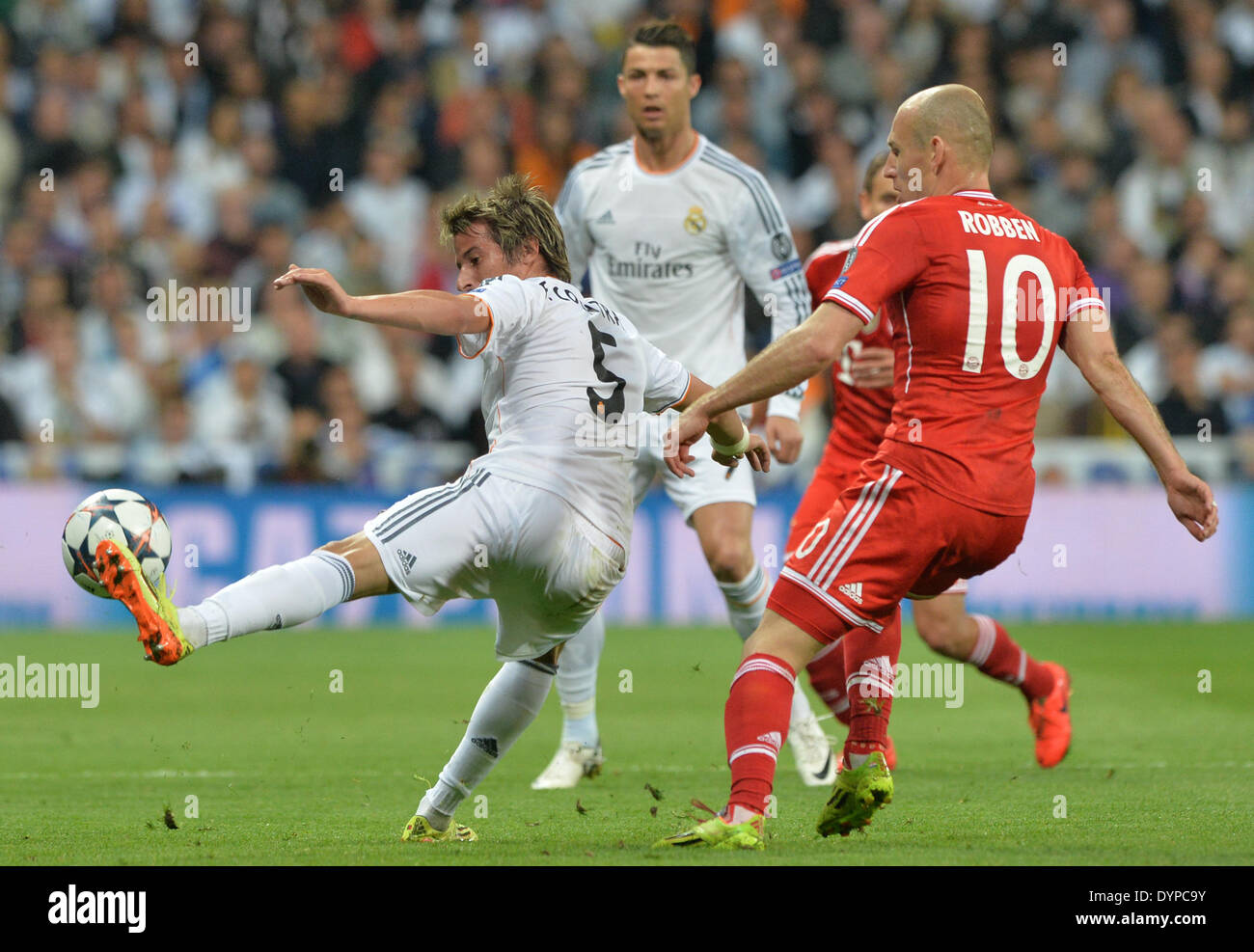 Munich's Arjen Robben (r) fights for the ball with Fabio Coentrao of Real Madrid during the UEFA Champions League semi final first leg soccer match between Real Madrid and FC Bayern Munich at Santiago Bernabeu stadium in Madrid, Spain, on 23 April 2014. Photo: Peter Kneffel/dpa Stock Photo