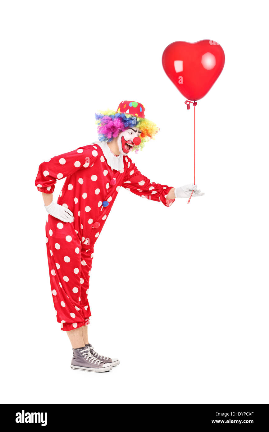 Male clown holding a red balloon Stock Photo