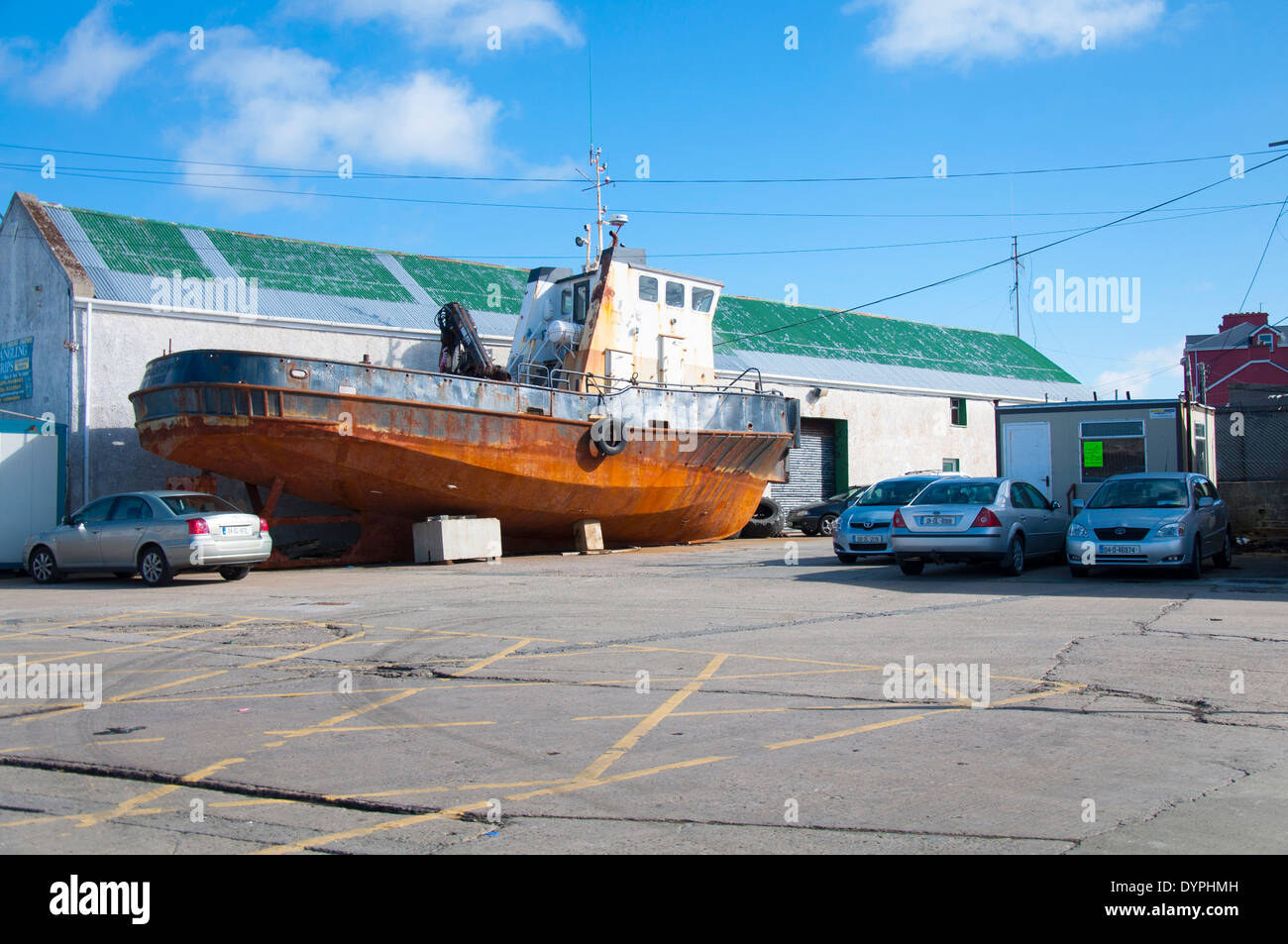 Rusty old tugboat in carpark at Burtonport County Donegal Ireland Stock