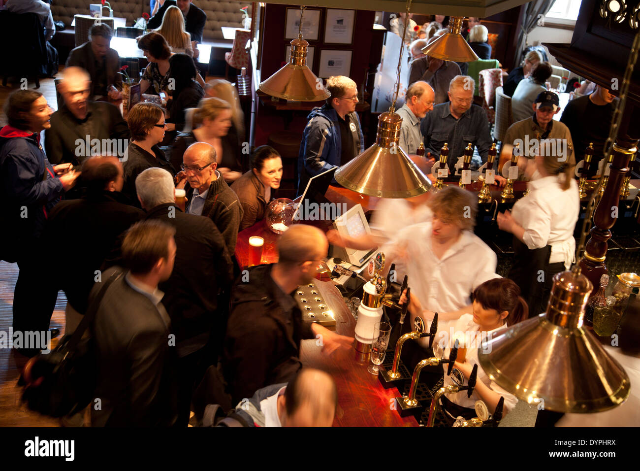 People drinking and chatting in the Haymarket Bar, a busy Edinburgh pub. Stock Photo