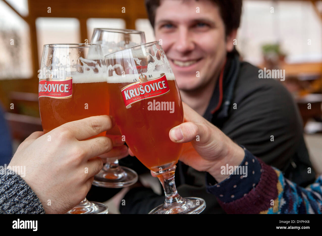 Men drinking beer Krusovice, cheers bar, Prague beer Czech Republic Stock Photo