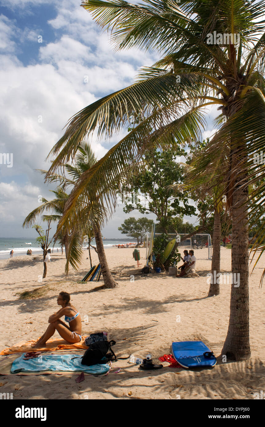 Woman taking sunbath on the beach hires stock photography and images