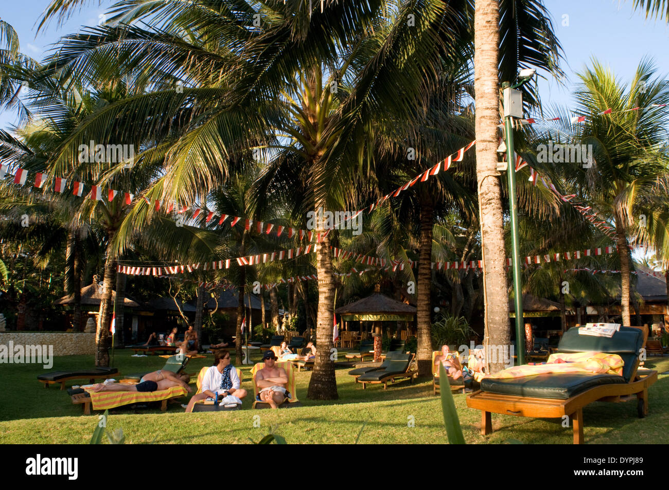 Tourists sunbathing on one of the many hotels in Legian. Surfers on the beach of Kuta. Surfing lessons. Bali. Kuta is a coastal Stock Photo