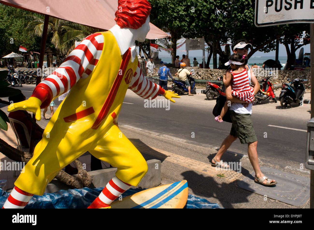 Snowman surfer Mc Donalds on the walk from the beach of Kuta. Bali. McDonalds restaurant, surfing Ronald McDonald statue, surfer Stock Photo