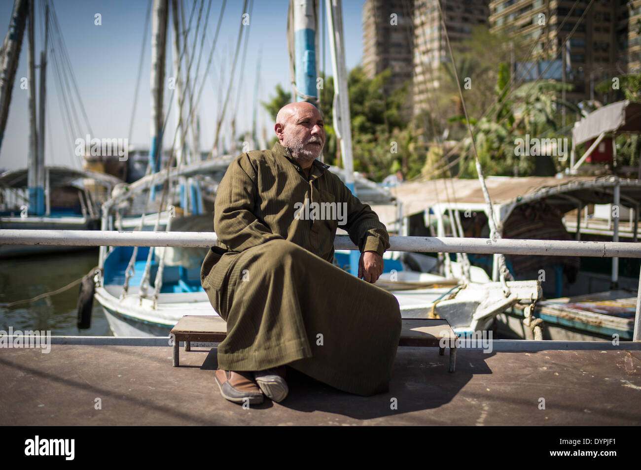 (140424) -- CAIRO, April 24, 2014 (Xinhua) -- Abdel Majid Yamama, 54, rests at a dock where he and his brother run the sailboat business by the Nile River in Maadi district, Cairo, capital of Egypt, on March 15, 2014. The Yamama family from Giza has lived on the Nile River for nearly one century. Presently Abdel Majid and his brother Abed Rabbo run the sailboat business for tourists at a dock in Maadi district of Cairo. The Yamama brothers and the boatmen they hire have seen a dramatic drop on business as a result of the depression in tourism since 2011, when the Revolution began throughout th Stock Photo