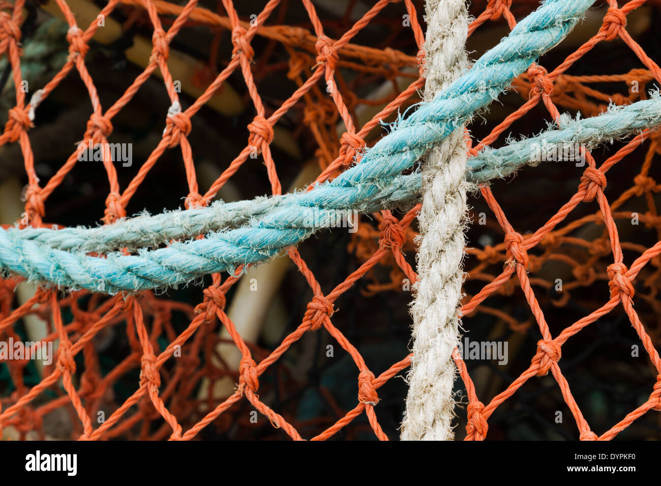 A close up detail of colourful lobster pots showing knots and rope used