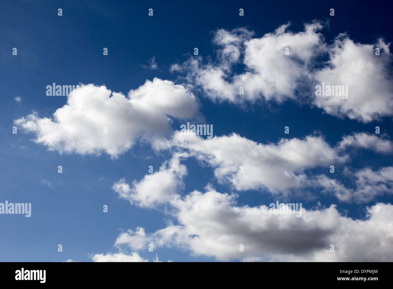 Blue Sky in early Spring time with white fluffy Cumulus Clouds. Stock Photo