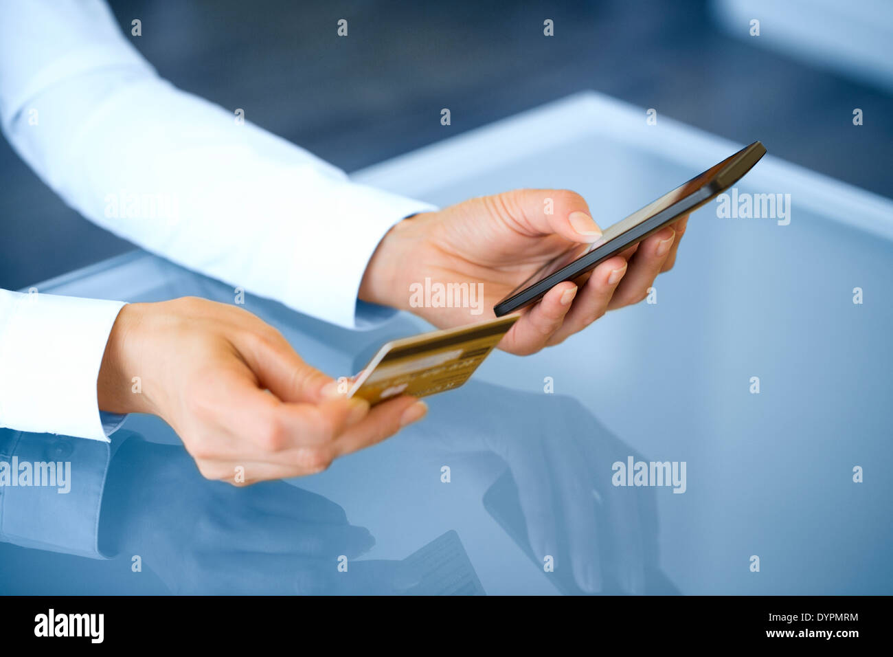 Woman shopping online using mobile phone and credit card .indoor.close-up Stock Photo