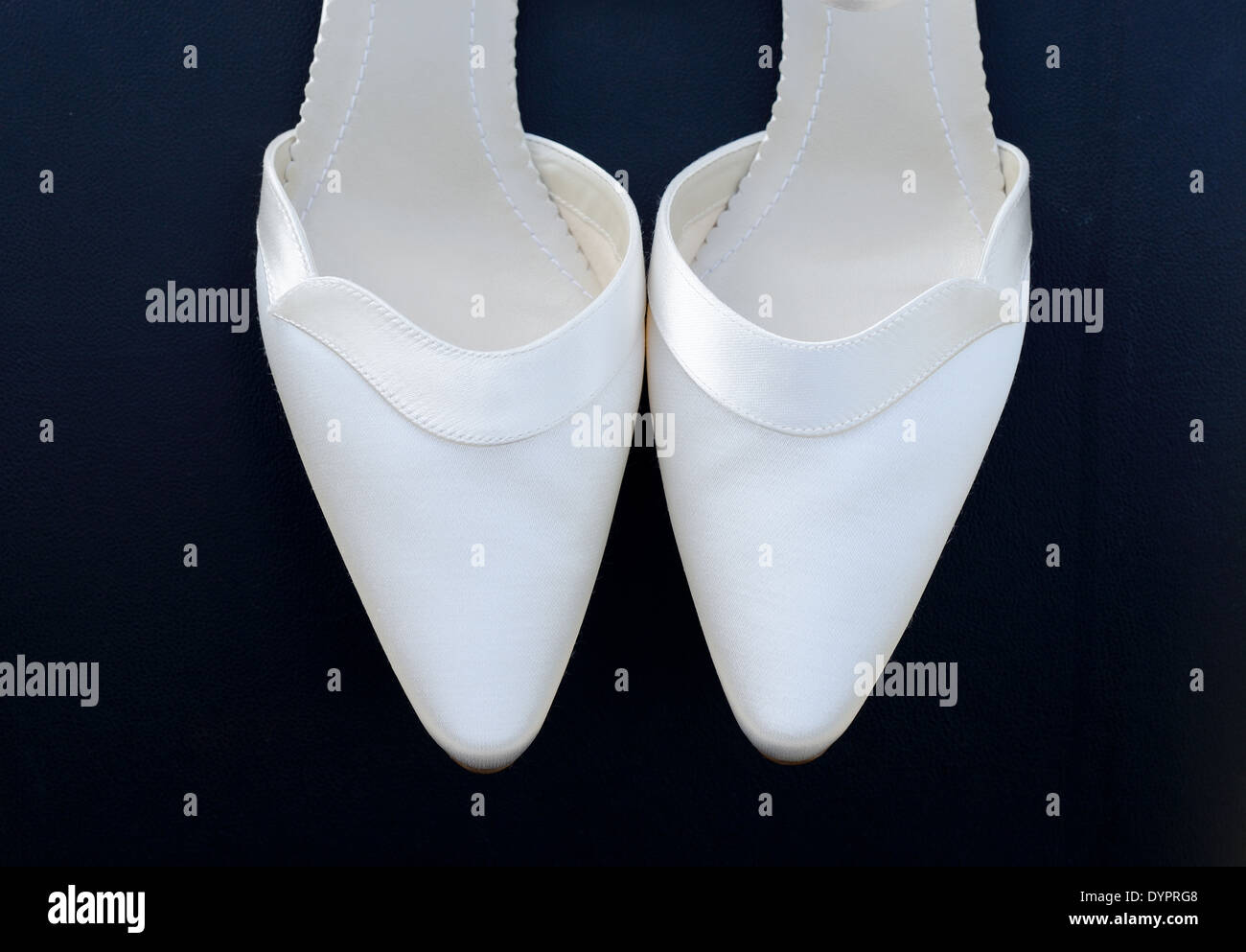 Pair of brides white shoes closeup Stock Photo