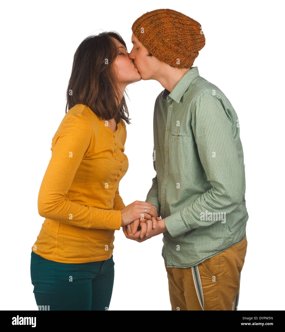 Beautiful young couple kissing against white background Stock Photo
