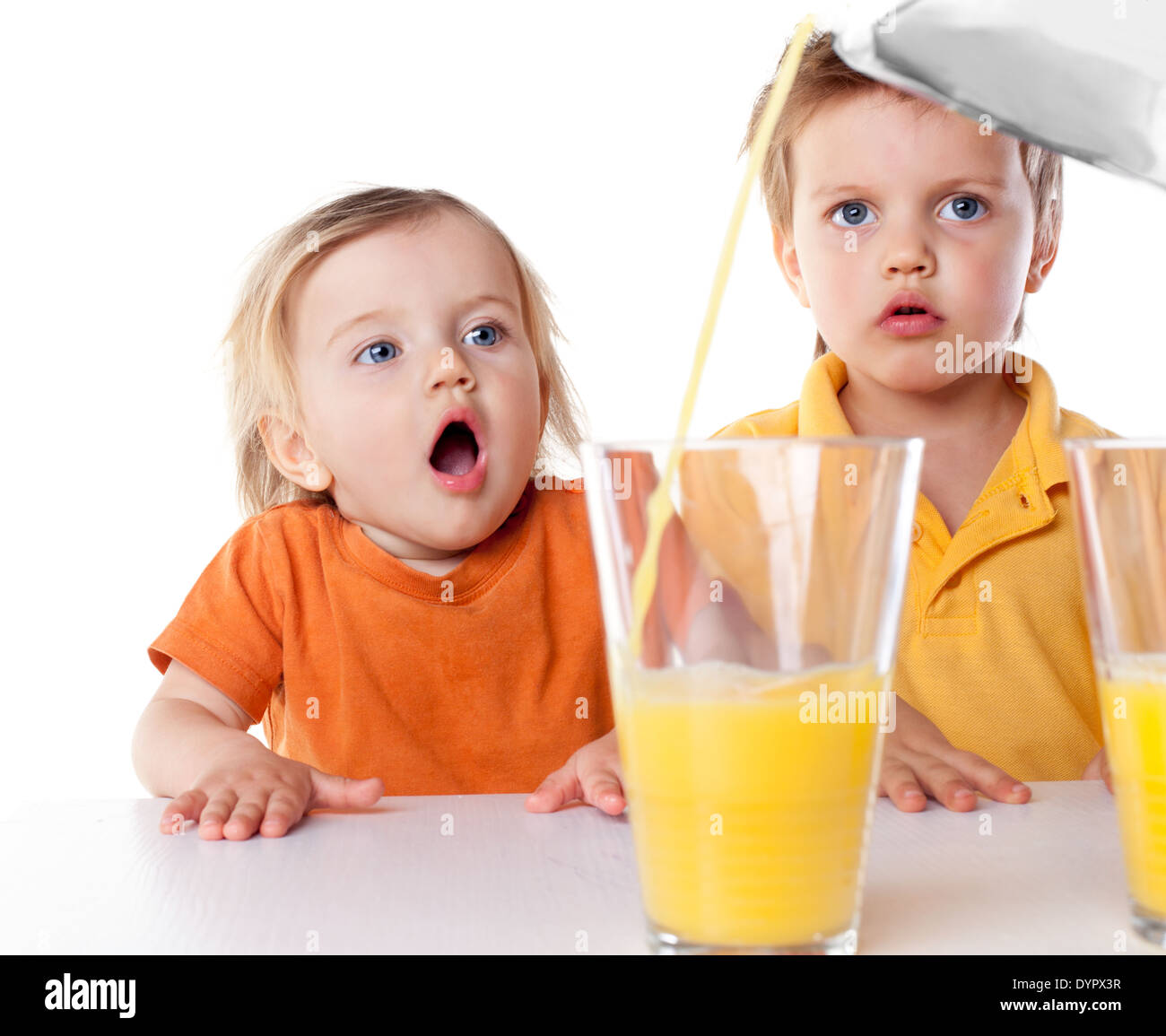 happy children drink orange juice isolated on white Stock Photo - Alamy