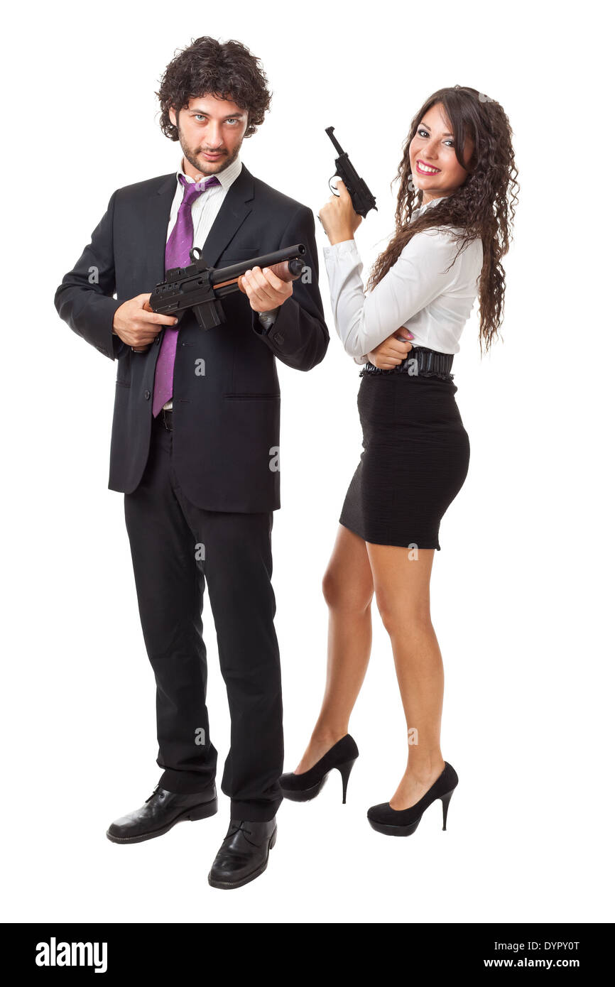 A businessman and a businesswoman (or maybe a couple of spies or gangster) holding guns over a white background Stock Photo