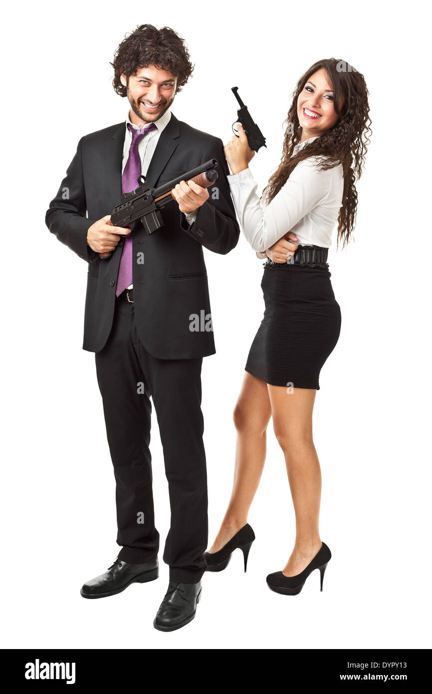 A businessman and a businesswoman (or maybe a couple of spies or gangster) holding guns over a white background Stock Photo