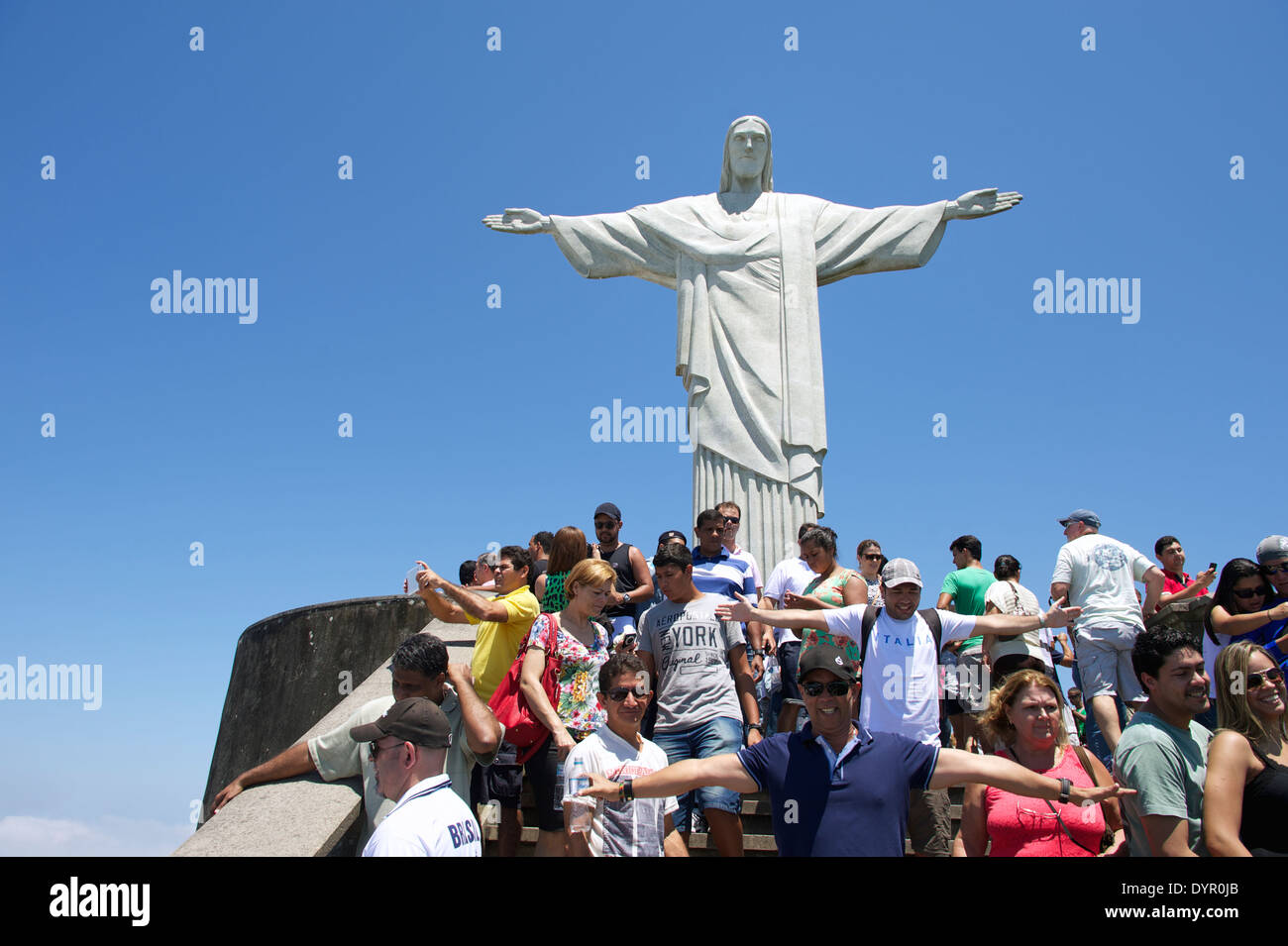 RIO DE JANEIRO, BRAZIL - OCTOBER 20, 2013: Tourists posing for pictures on the viewing platform at the statue of Christ the Rede Stock Photo