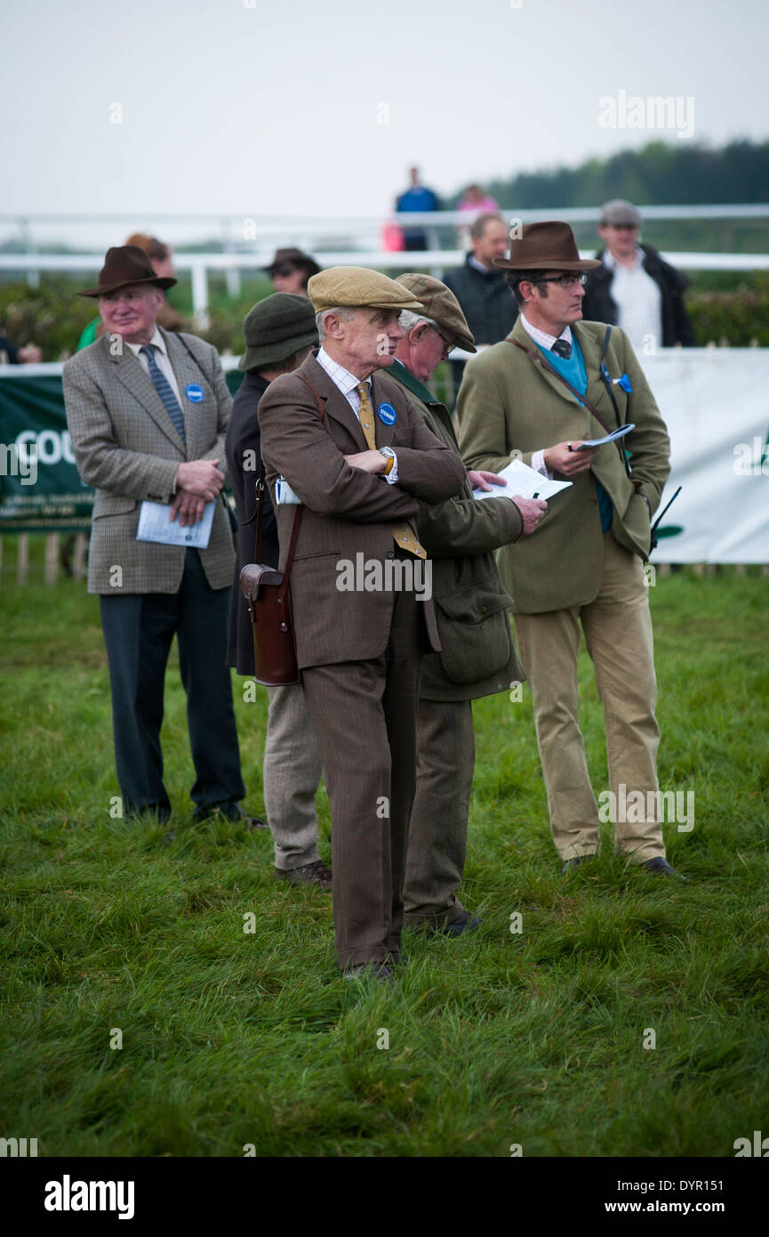 Owners and traners watching horses in parade ring Stock Photo