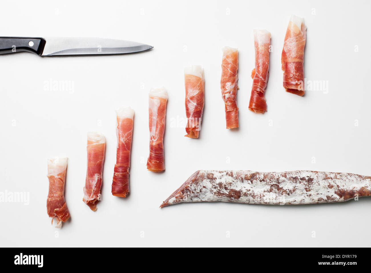Rolls of Spanish ham, chorizo and fuet sausages Stock Photo