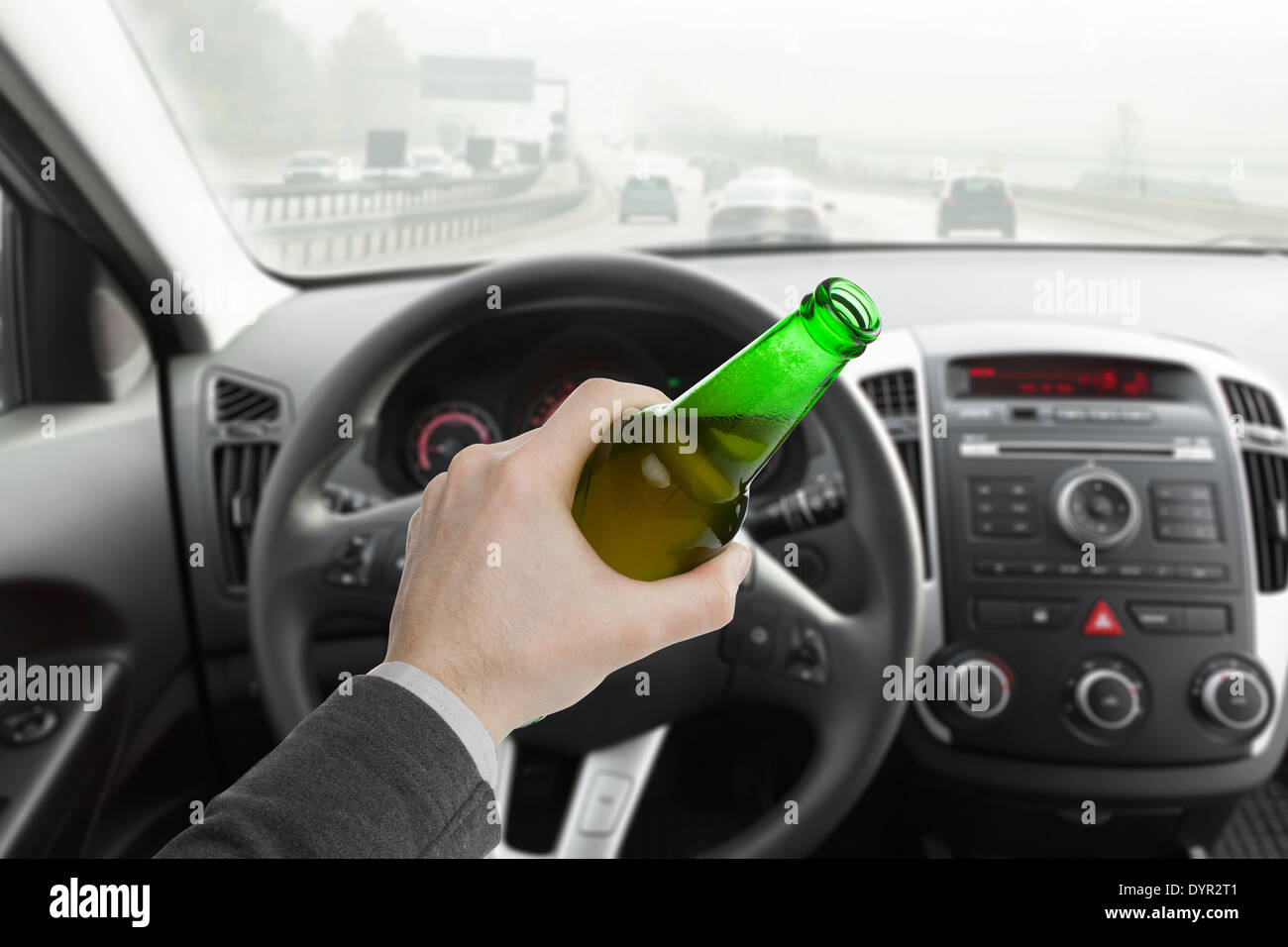 Man hand holding bottle of beer while driving car Stock Photo - Alamy