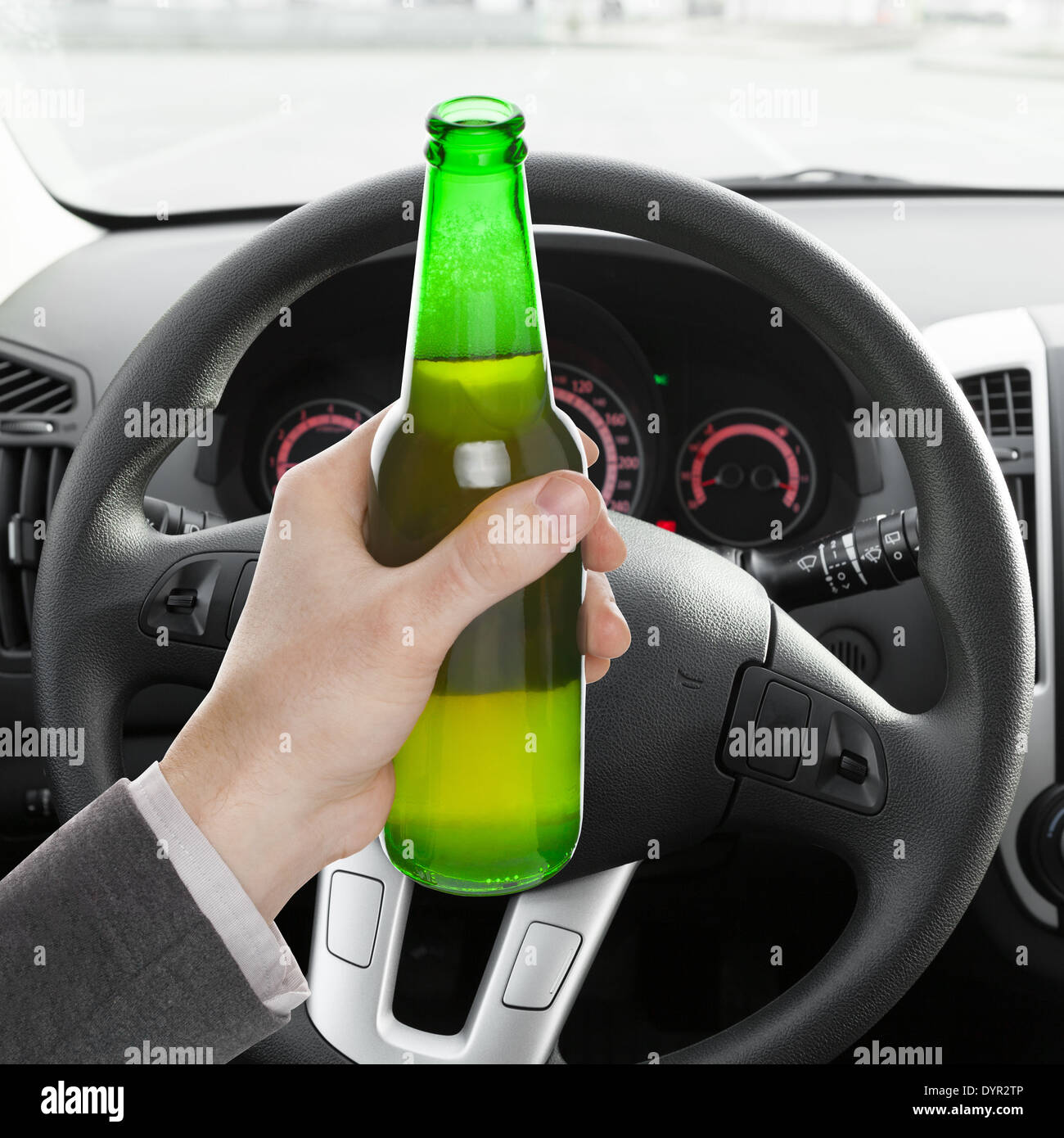 Male hand holding bottle of beer while driving car - 1 to 1 ratio Stock ...