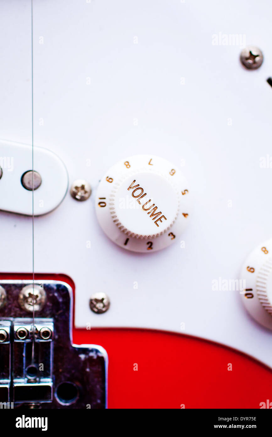 A vintage electric guitar's volume control dial. Focus on 'volume
