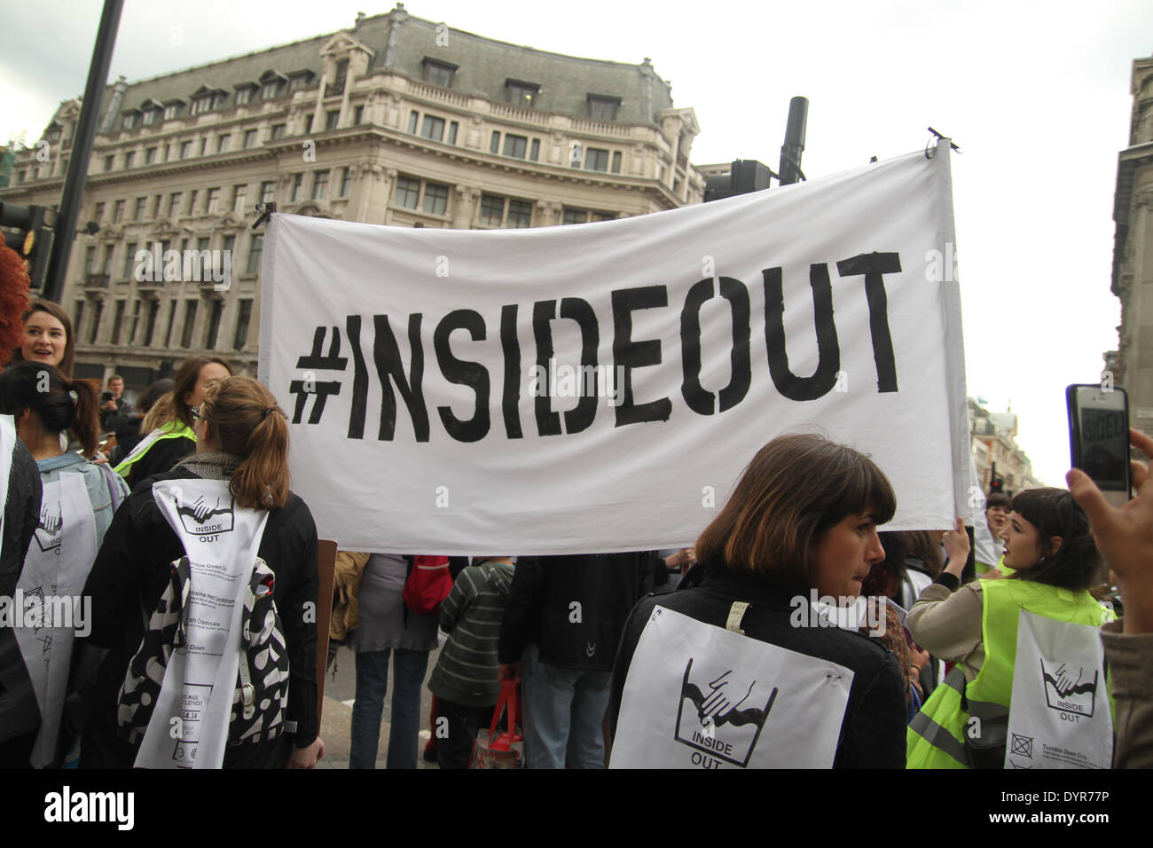 London, UK. 24th April 2014. A group of protesters carrying a banner with the words 'Inside Out' chant 'Who made your clothes' Credit:  david mbiyu/Alamy Live News Stock Photo