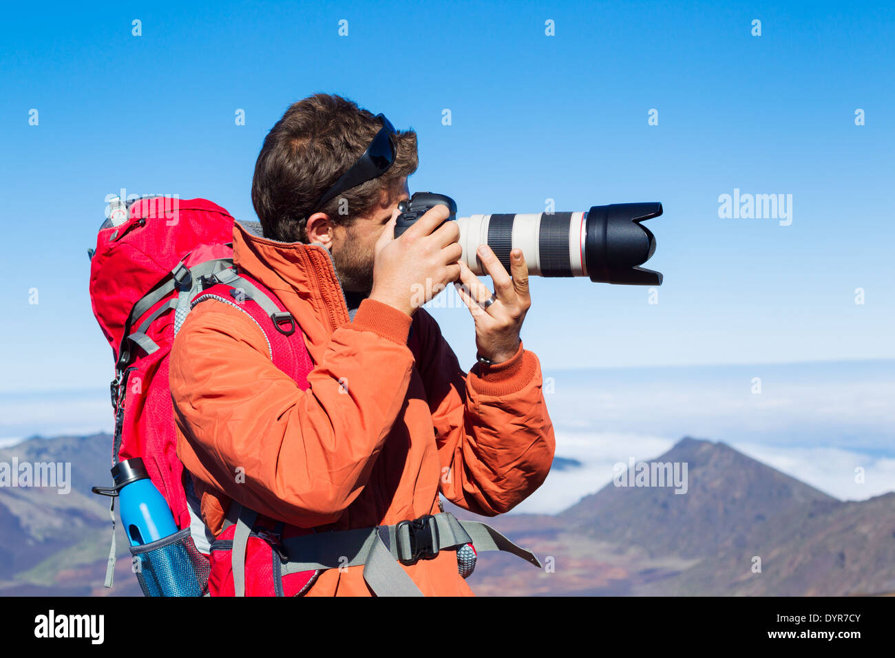 Photographer taking pictures outdoors on hiking trip. Outdoor nature photography. Stock Photo