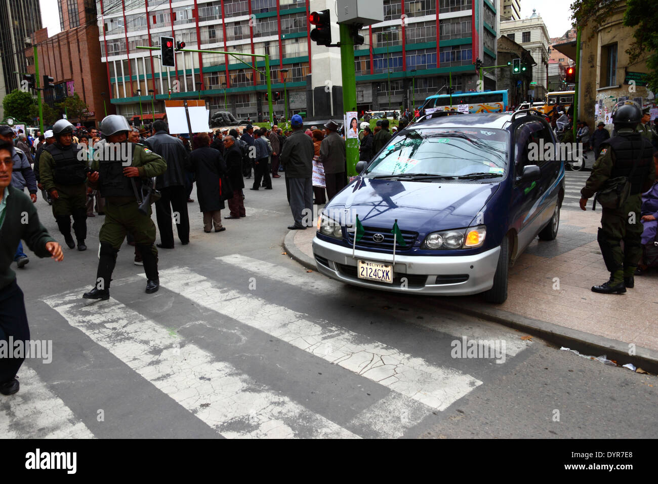 A taxi turns round to avoid a road block during a protest by retired teachers over their pension payments , La Paz, Bolivia Stock Photo