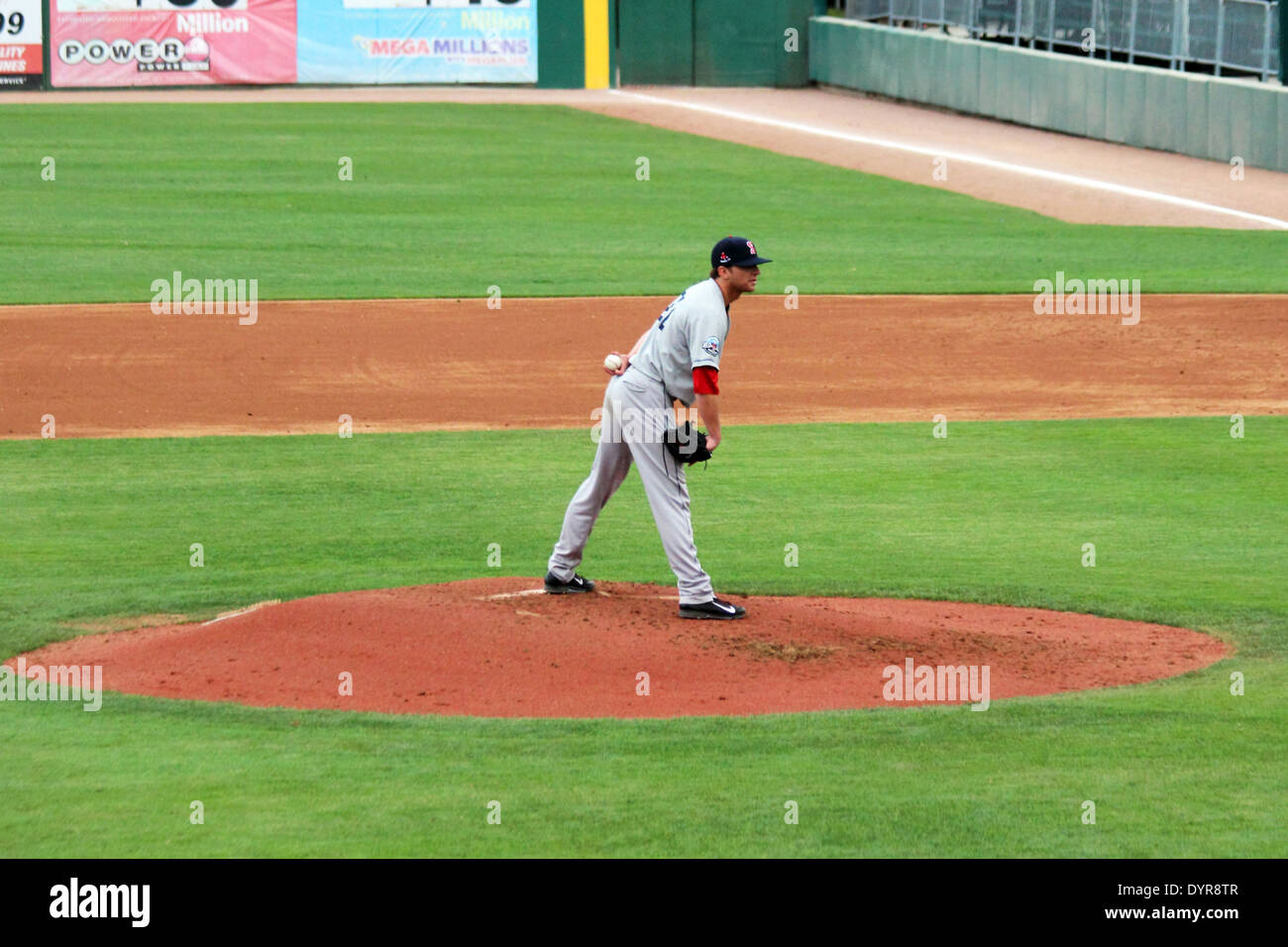 A baseball pitcher readies himself on the mound and looks for a sign from the catcher. Stock Photo