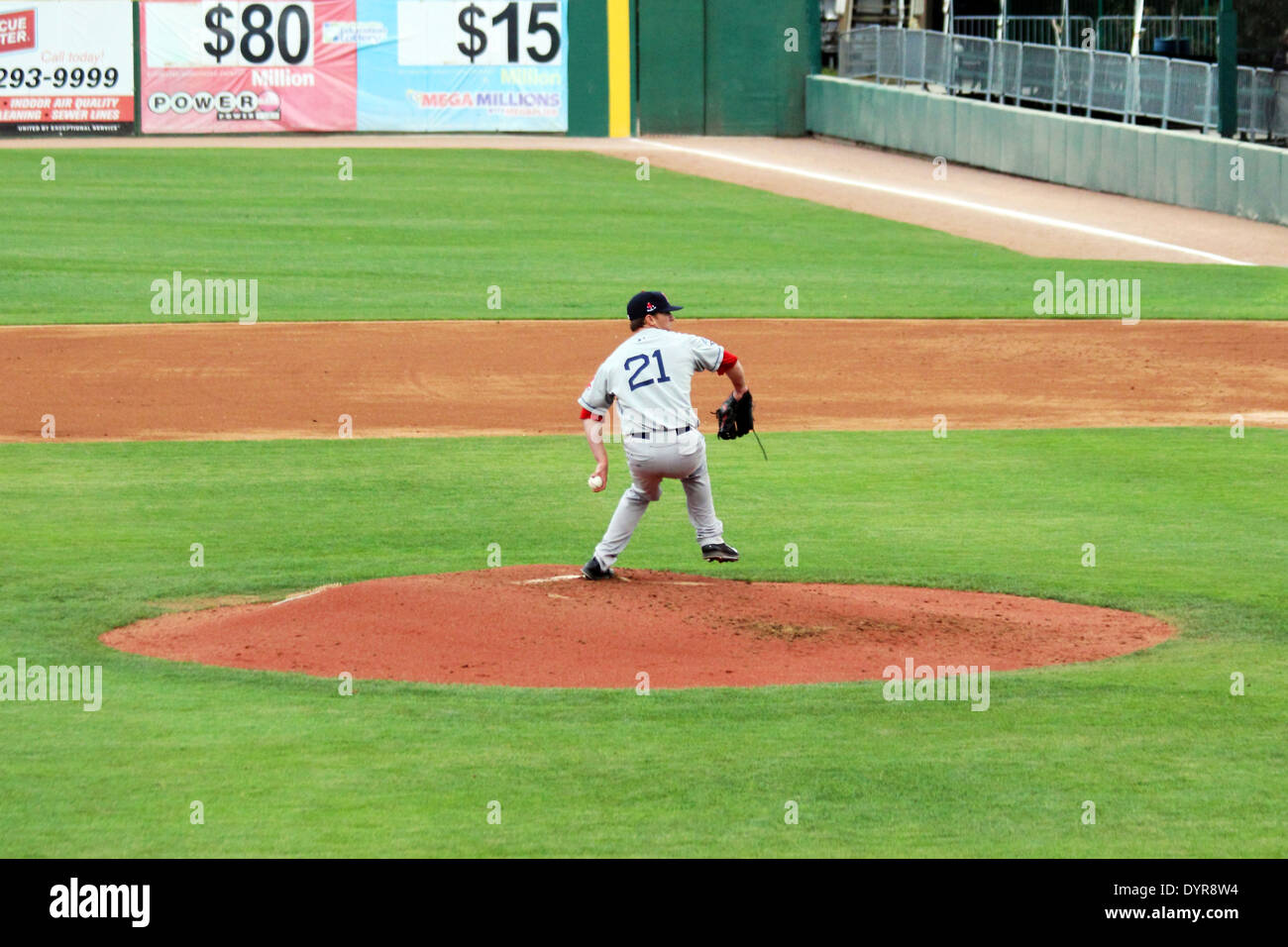A baseball pitcher delivers a pitch from the mound Stock Photo Alamy
