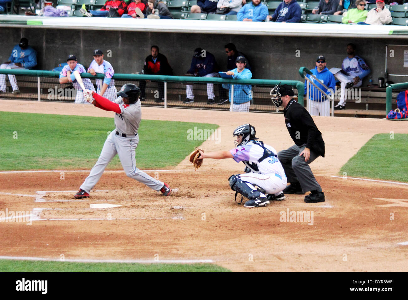 A baseball batter swings at a pitch. Stock Photo