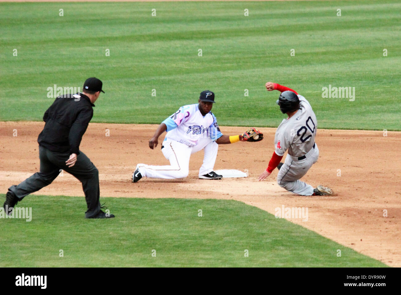 A runner slides into second attempting to steal second base. Stock Photo