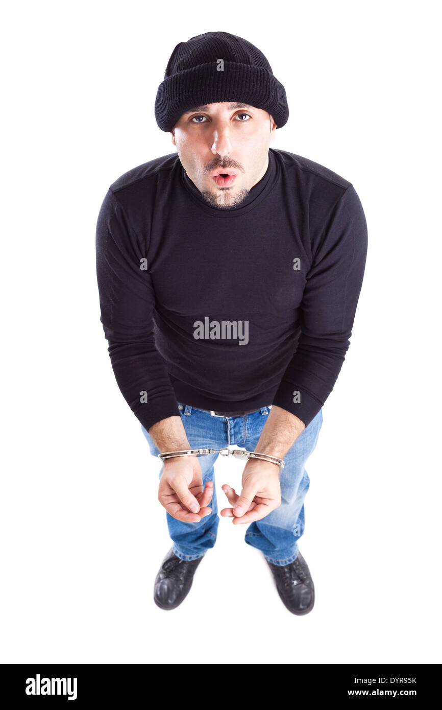 a young thief or burglar with handcuffs on Stock Photo