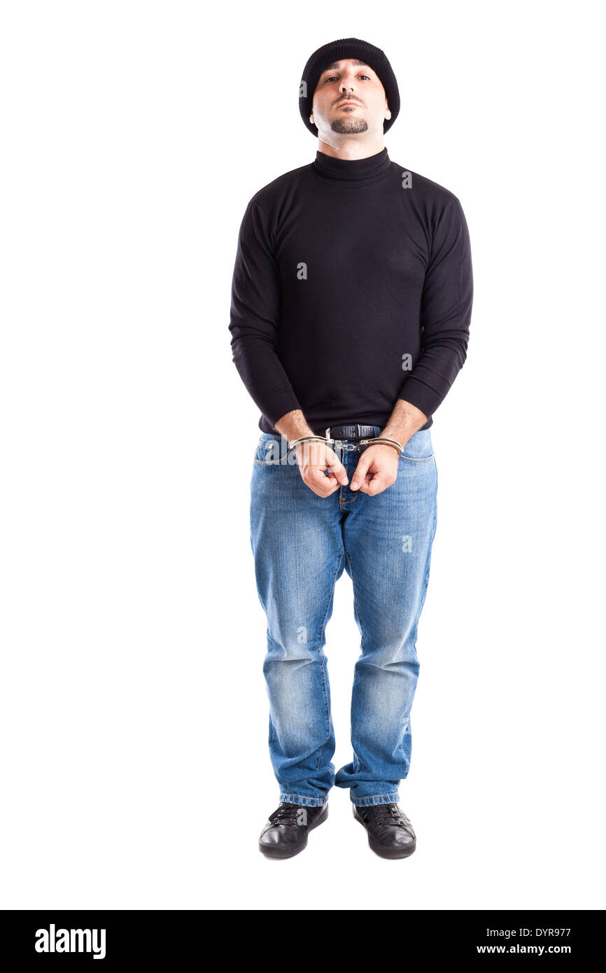 a young thief or burglar with handcuffs on Stock Photo