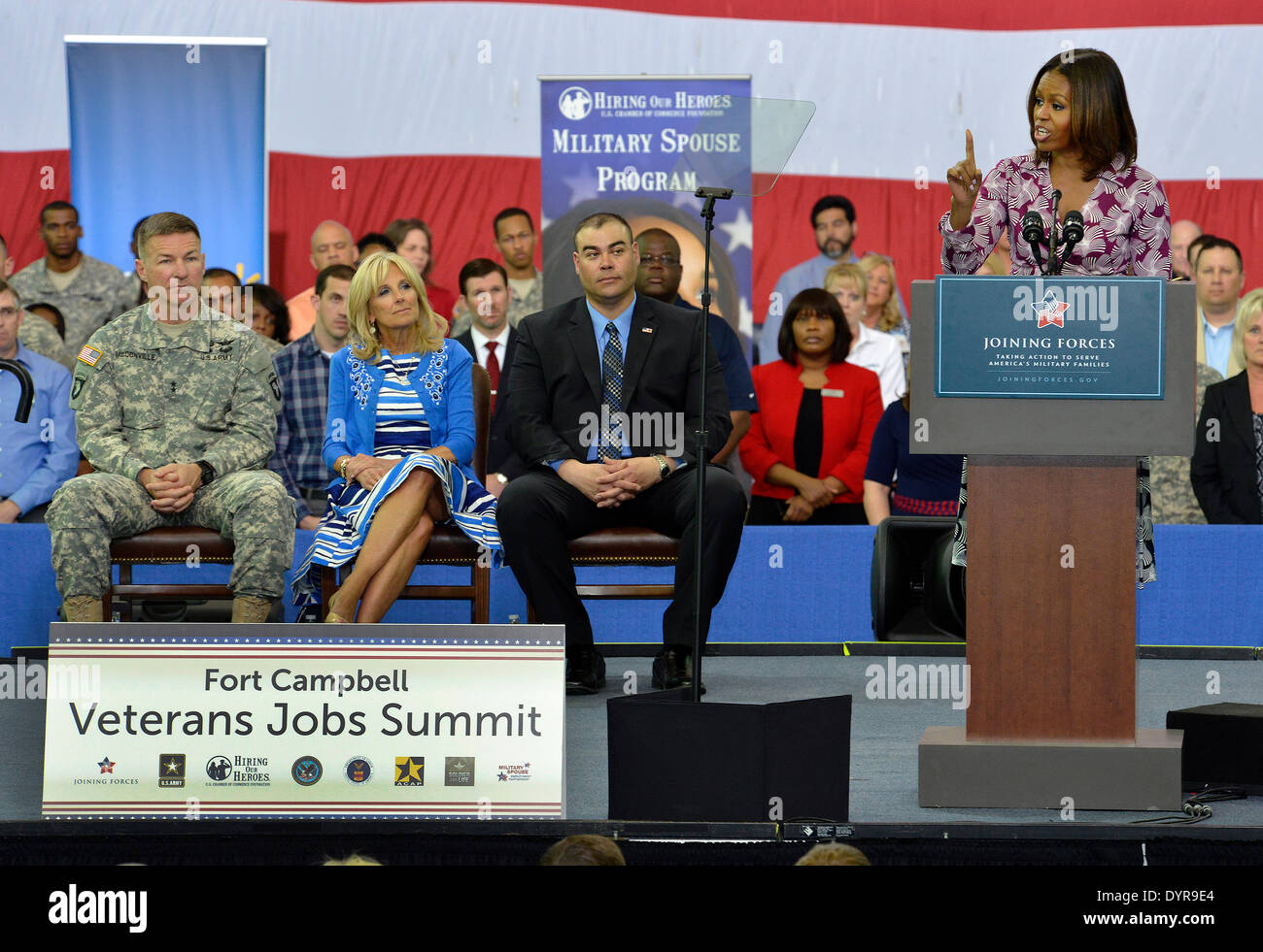 US First lady Michelle Obama speaks to soldiers, family members and employers during a veterans job summit and career forum at Fort Campbell April 23, 2014, Hopkinsville, Kentucky. From left, Army Maj. Gen. James McConville, the commanding general of the 101st Airborne Division, Jill Biden and Sgt. Aaron Wanlessr, with the 4th Brigade Combat Team. Stock Photo